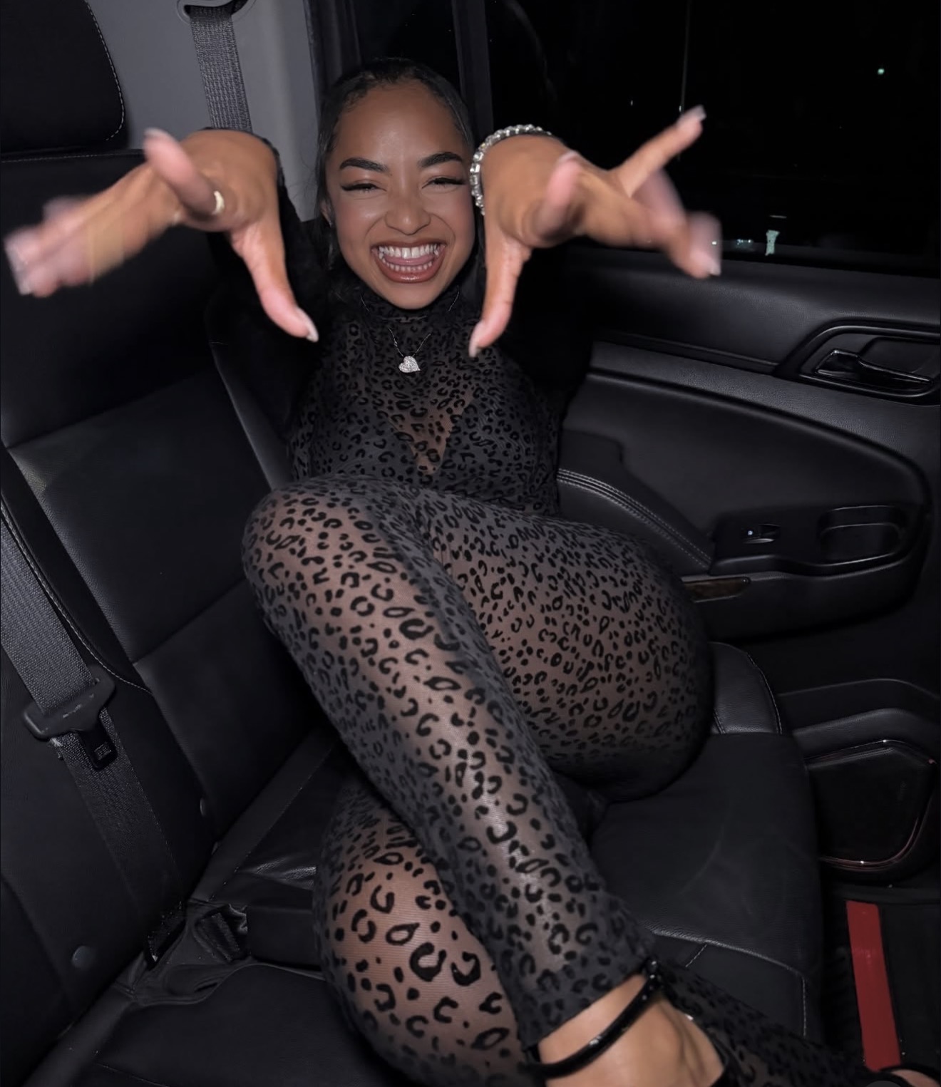 Ki’Loni Lee smiling and reaching toward the camera.